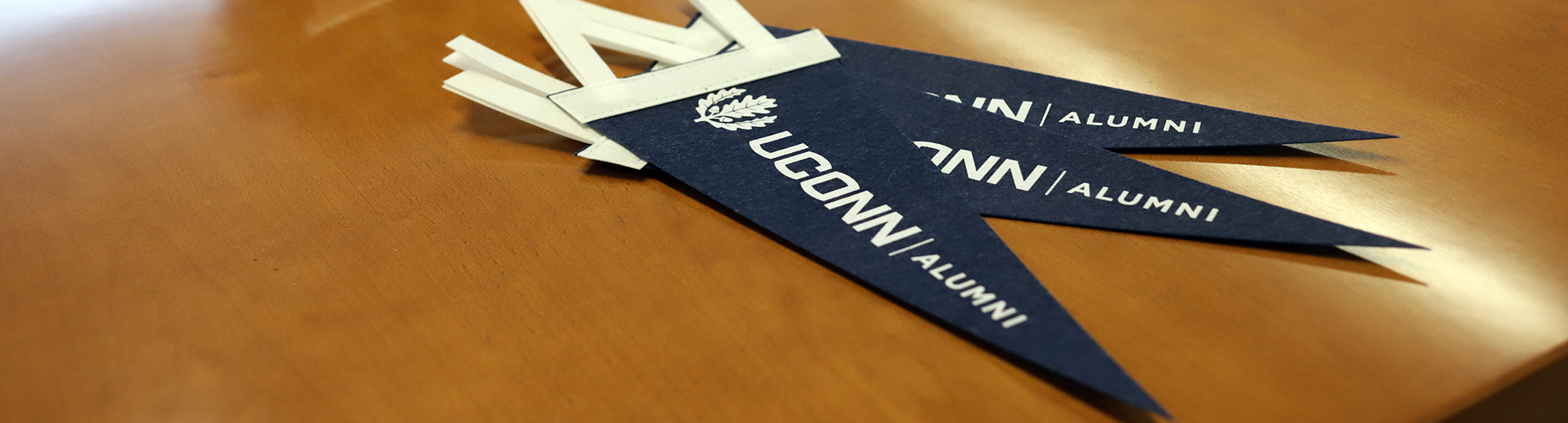 UConn alumni pennants on a table